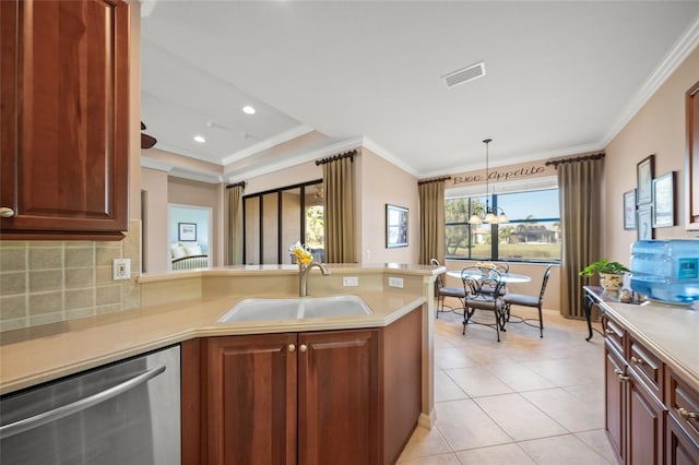 kitchen with sink, dishwasher, kitchen peninsula, and hanging light fixtures