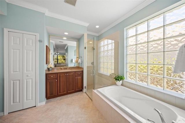 bathroom featuring plus walk in shower, ornamental molding, vanity, and tile patterned floors