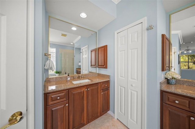 bathroom with vanity, crown molding, plenty of natural light, and tile patterned floors