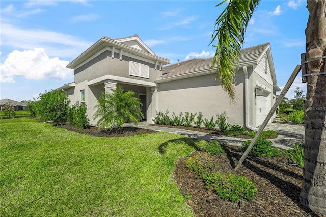 view of side of property with a garage and a lawn