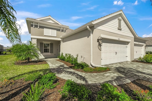 view of front facade with a garage and a front lawn