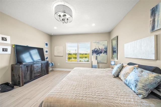 bedroom featuring a textured ceiling and light wood-type flooring