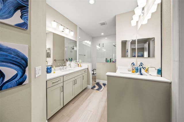 bathroom with vanity, hardwood / wood-style floors, and walk in shower