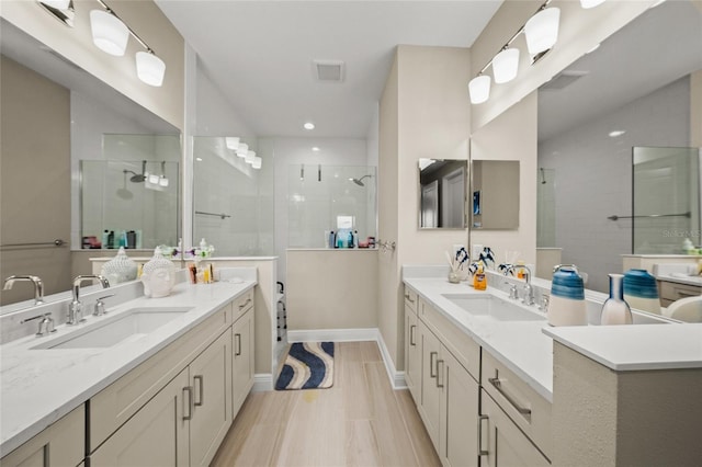 bathroom featuring vanity, wood-type flooring, and a shower with shower door