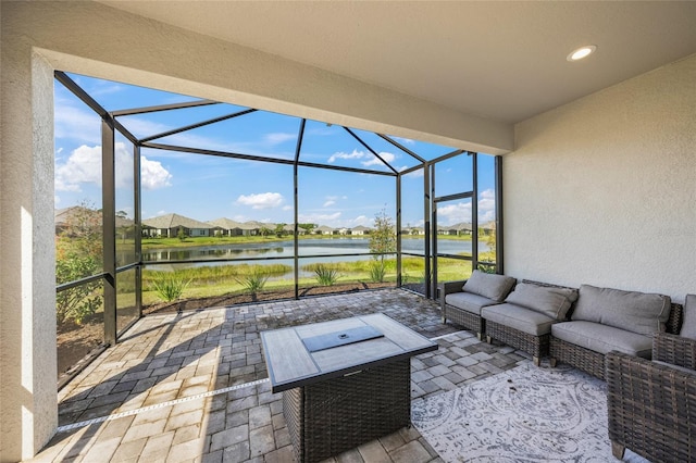 view of patio featuring a water view, an outdoor hangout area, and a lanai