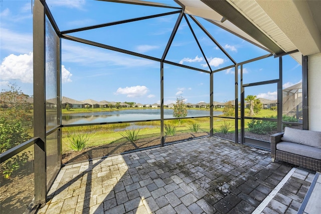 unfurnished sunroom with a water view