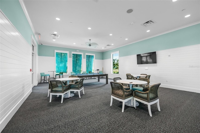 carpeted dining area featuring ceiling fan and ornamental molding