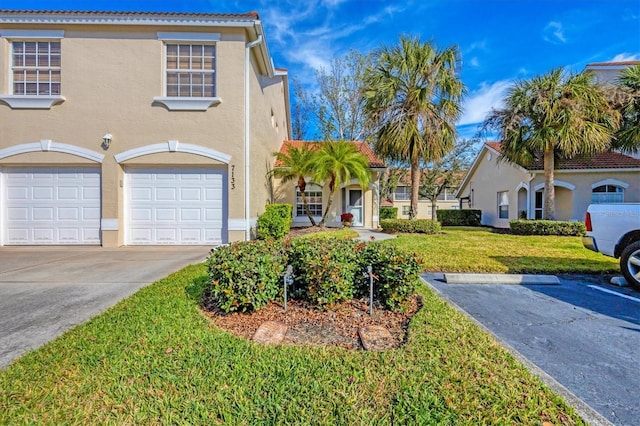 mediterranean / spanish house with a garage and a front yard