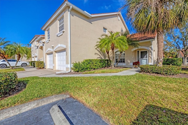 view of front of property with a garage and a front yard