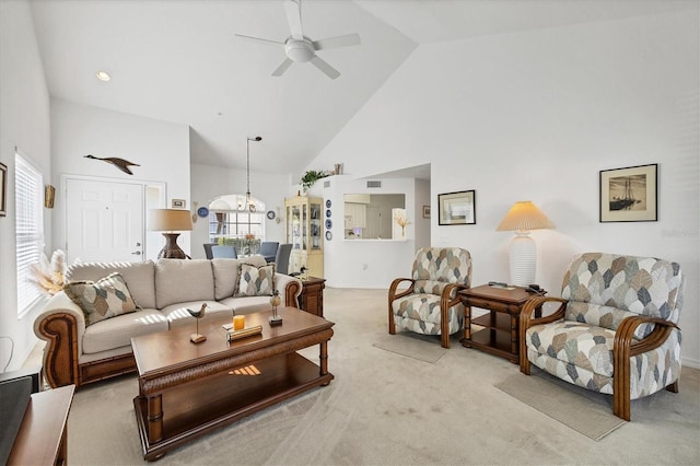 living room featuring high vaulted ceiling, light colored carpet, and ceiling fan