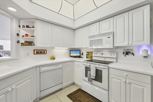 kitchen featuring white cabinetry, white appliances, and light tile patterned flooring