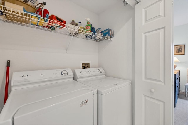 clothes washing area with washing machine and clothes dryer