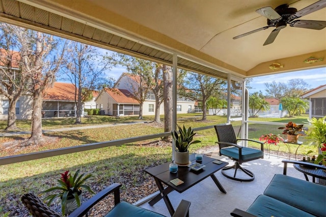 sunroom with lofted ceiling and ceiling fan