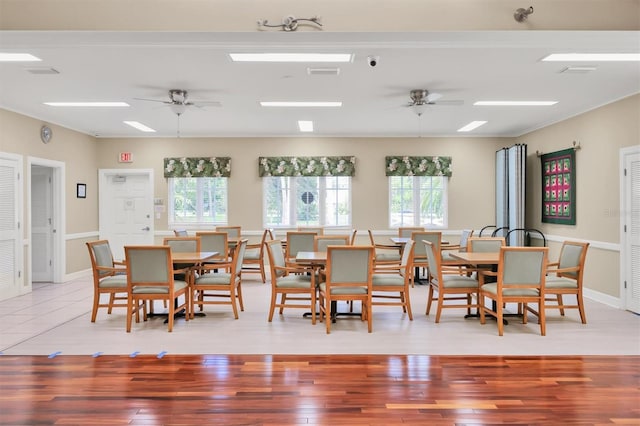 dining space with light wood-type flooring, a wealth of natural light, and ceiling fan