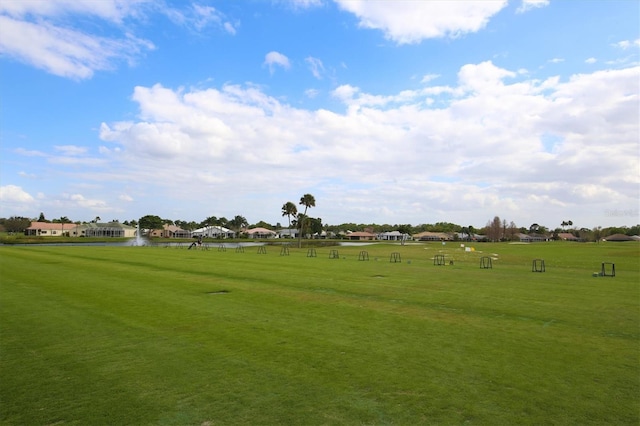 view of property's community featuring a water view and a lawn