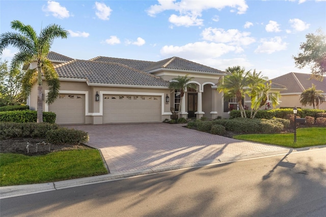 mediterranean / spanish home featuring a garage