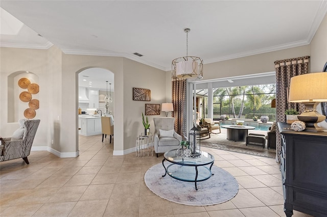 living area with light tile patterned flooring, crown molding, and sink