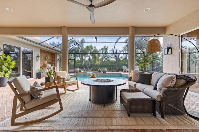 sunroom featuring ceiling fan