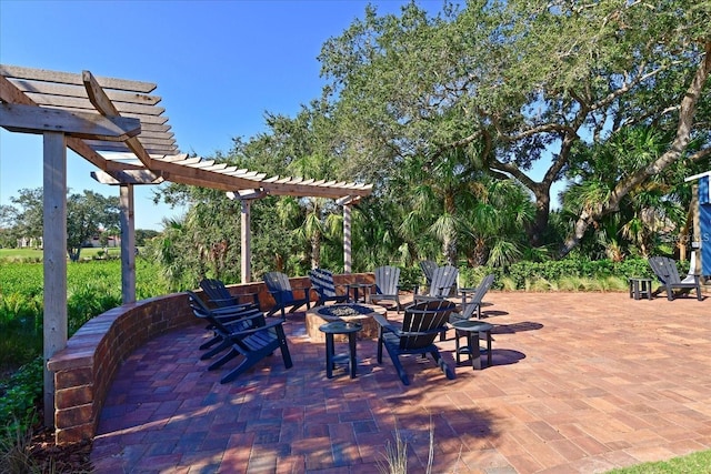 view of patio with an outdoor fire pit and a pergola