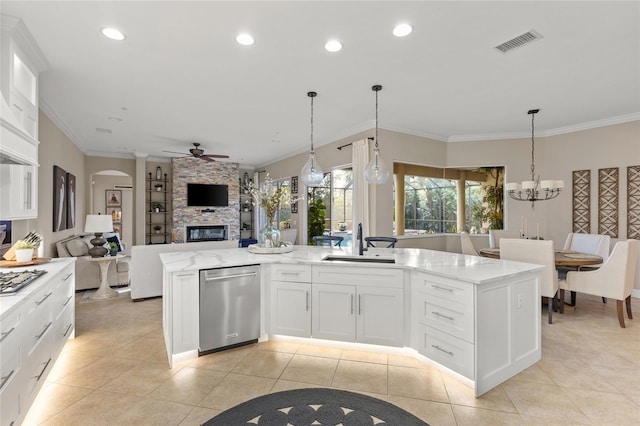 kitchen featuring pendant lighting, sink, appliances with stainless steel finishes, an island with sink, and white cabinets