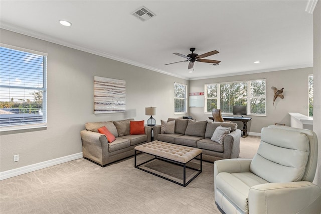 living room with ornamental molding, a healthy amount of sunlight, and light colored carpet