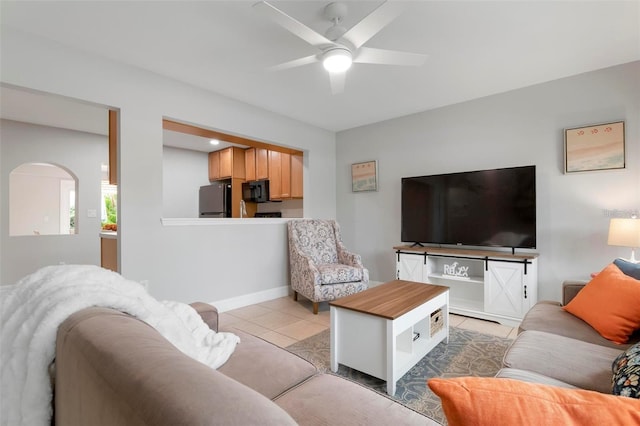 living room featuring ceiling fan and light tile patterned flooring