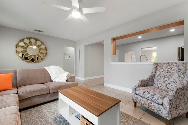 living room featuring light tile patterned floors and ceiling fan