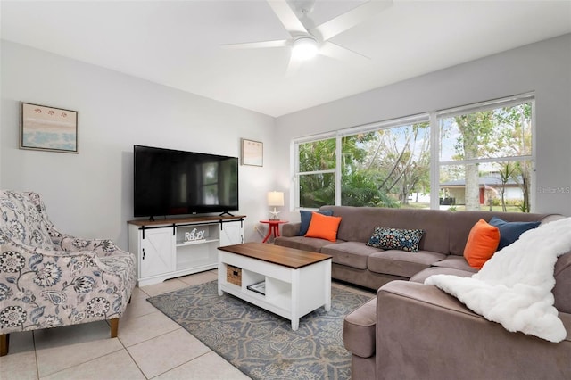 tiled living room with a wealth of natural light and ceiling fan