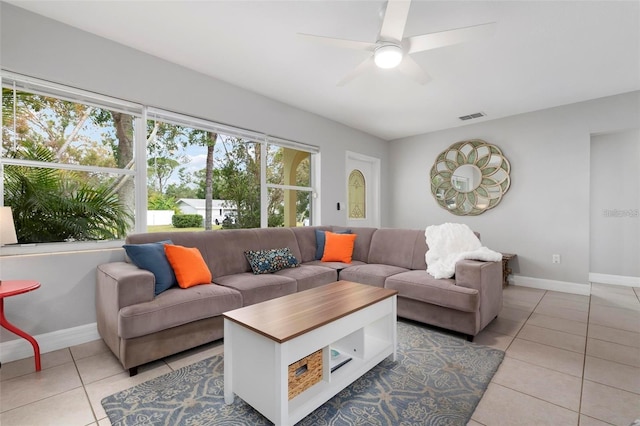 tiled living room with ceiling fan