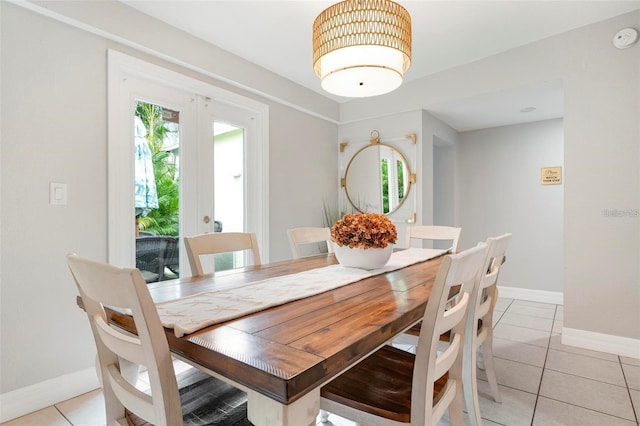 dining area with light tile patterned floors and french doors