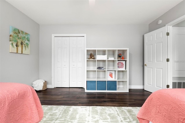 bedroom featuring dark hardwood / wood-style floors and a closet