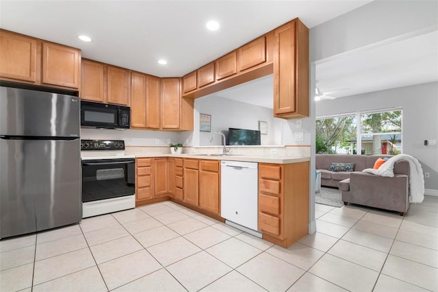 kitchen featuring sink, white appliances, light tile patterned floors, and ceiling fan