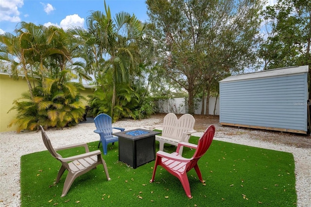 view of patio featuring a storage unit and a fire pit