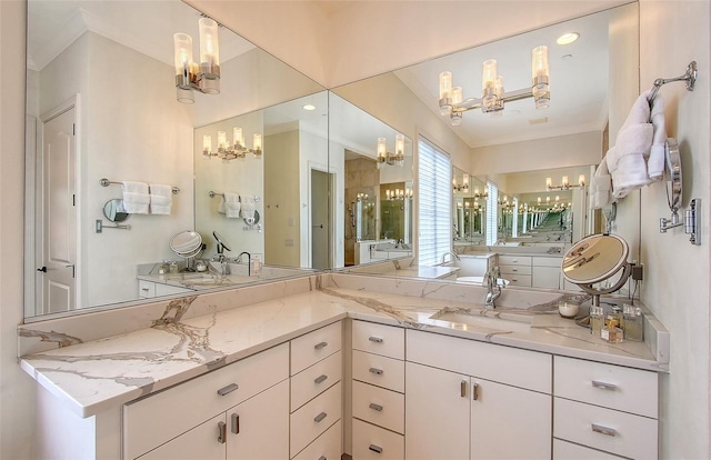 bathroom featuring an inviting chandelier and vanity