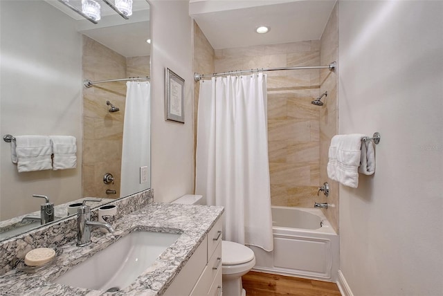 full bathroom with vanity, wood-type flooring, shower / bath combination with curtain, and toilet