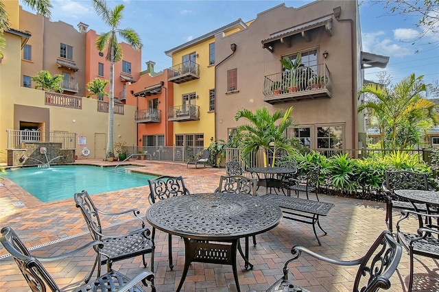 view of pool featuring pool water feature and a patio