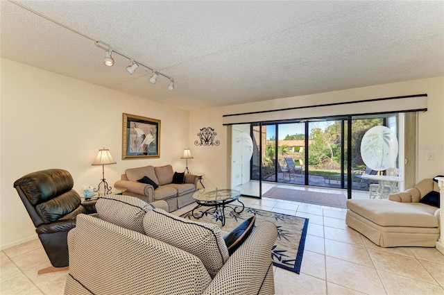 tiled living room with rail lighting and a textured ceiling