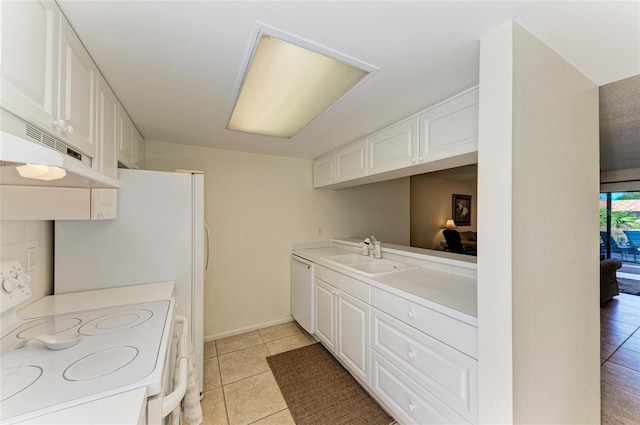 kitchen featuring light tile patterned flooring, sink, white cabinets, and white appliances