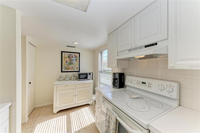 kitchen with white cabinetry, white electric range, light tile patterned flooring, and backsplash