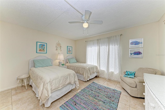 tiled bedroom featuring ceiling fan and a textured ceiling