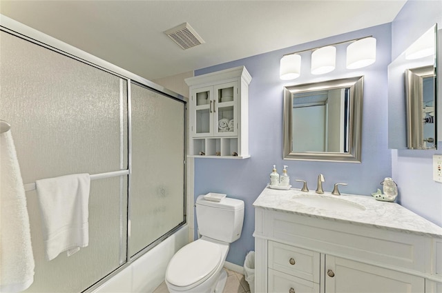 full bathroom with enclosed tub / shower combo, vanity, toilet, and tile patterned flooring