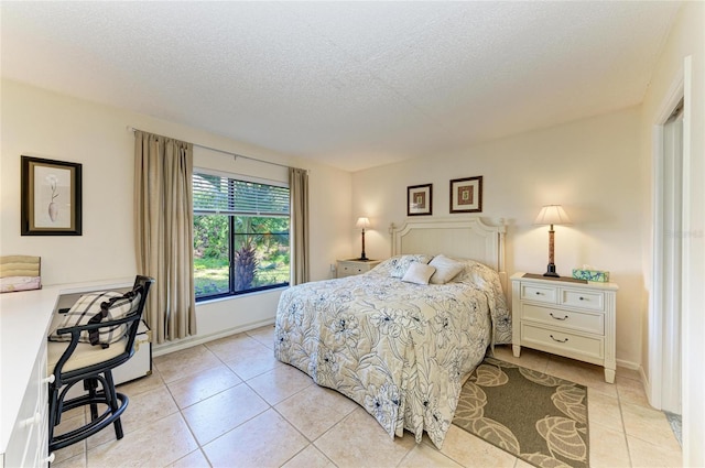 tiled bedroom with a textured ceiling