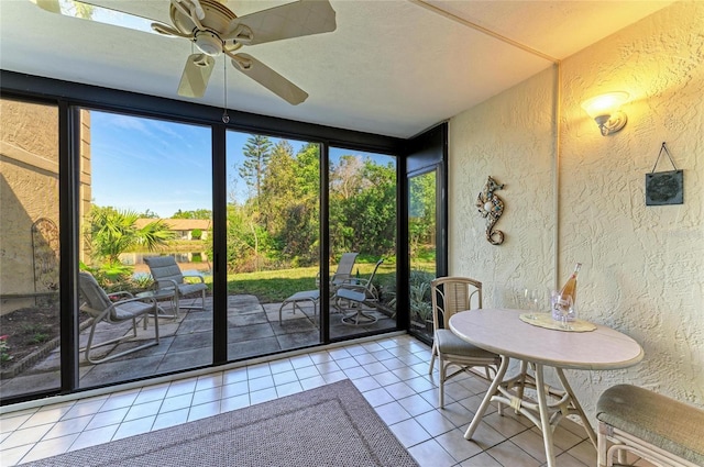 unfurnished sunroom featuring a wealth of natural light and ceiling fan