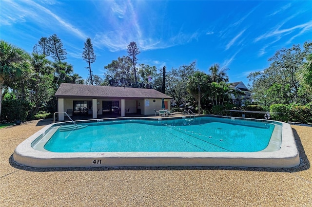 view of swimming pool featuring a patio area