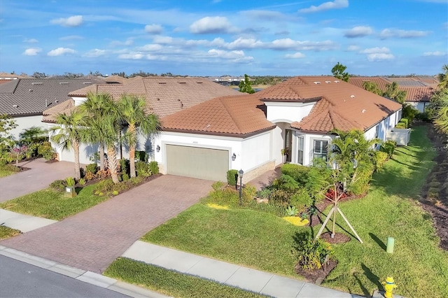 mediterranean / spanish-style home featuring a garage and a front yard