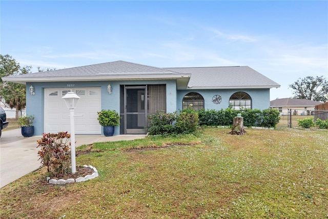 single story home with a garage and a front lawn