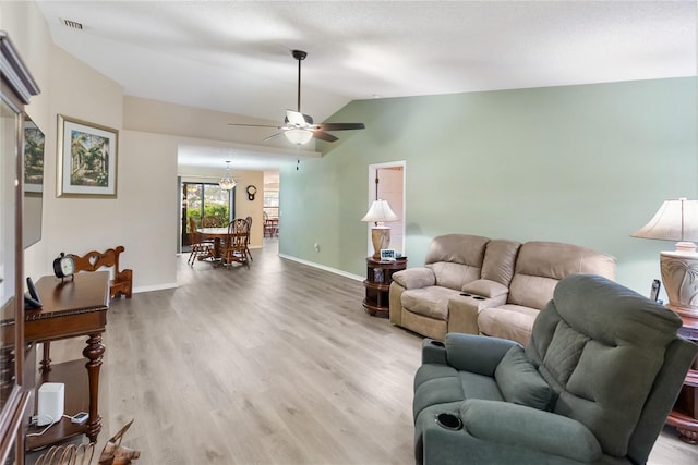 living room featuring wood-type flooring, vaulted ceiling, and ceiling fan