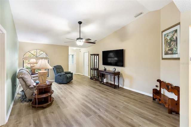 sitting room featuring ceiling fan, lofted ceiling, and wood-type flooring