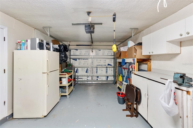 garage featuring a garage door opener and white refrigerator