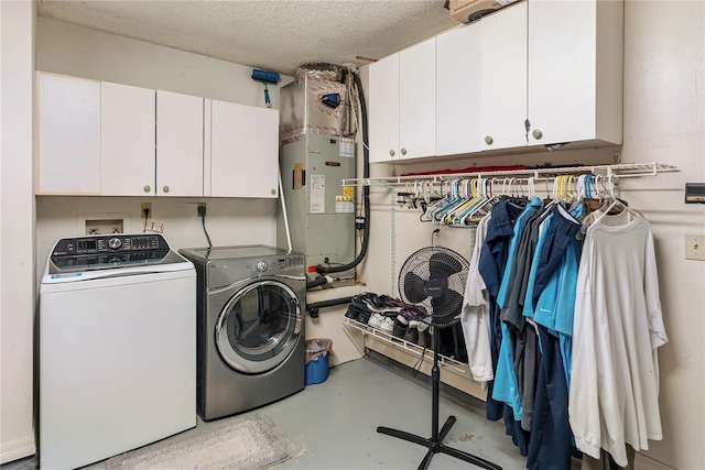 laundry room with separate washer and dryer, cabinets, and a textured ceiling